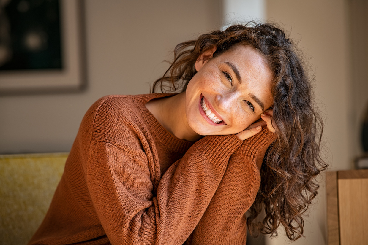 Smiling Young Woman Relaxing at Home